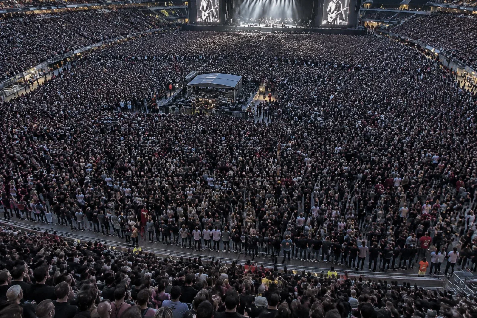 A vast stadium crowd during a live concert